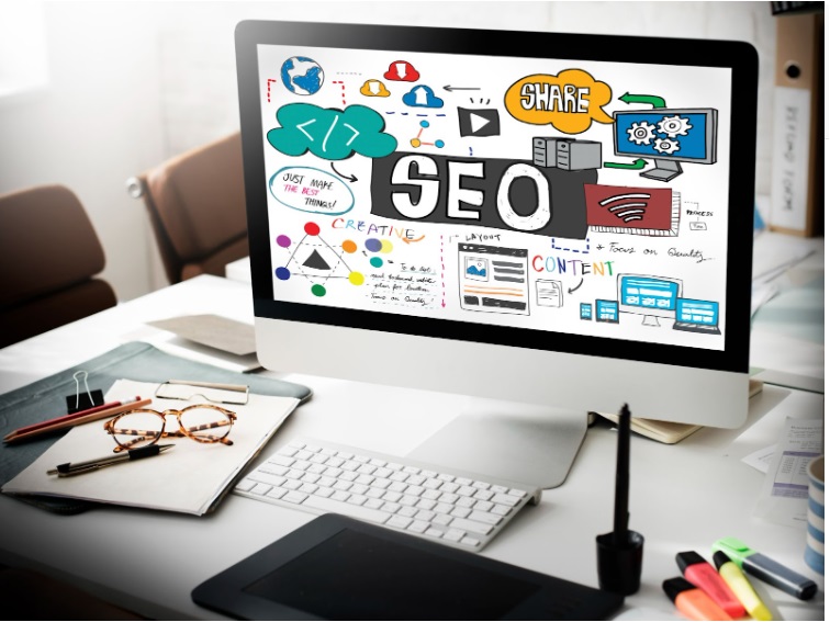 Imagem em IA de uma mesa com uma tela de computador sobre ela. Na rela está a palavra SEO e alguns elementos